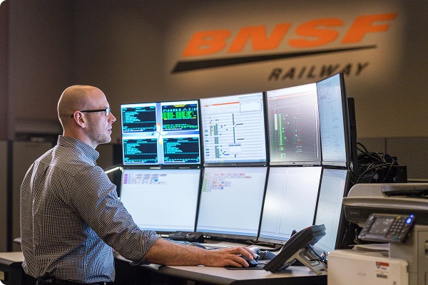 man looking at multiple screens