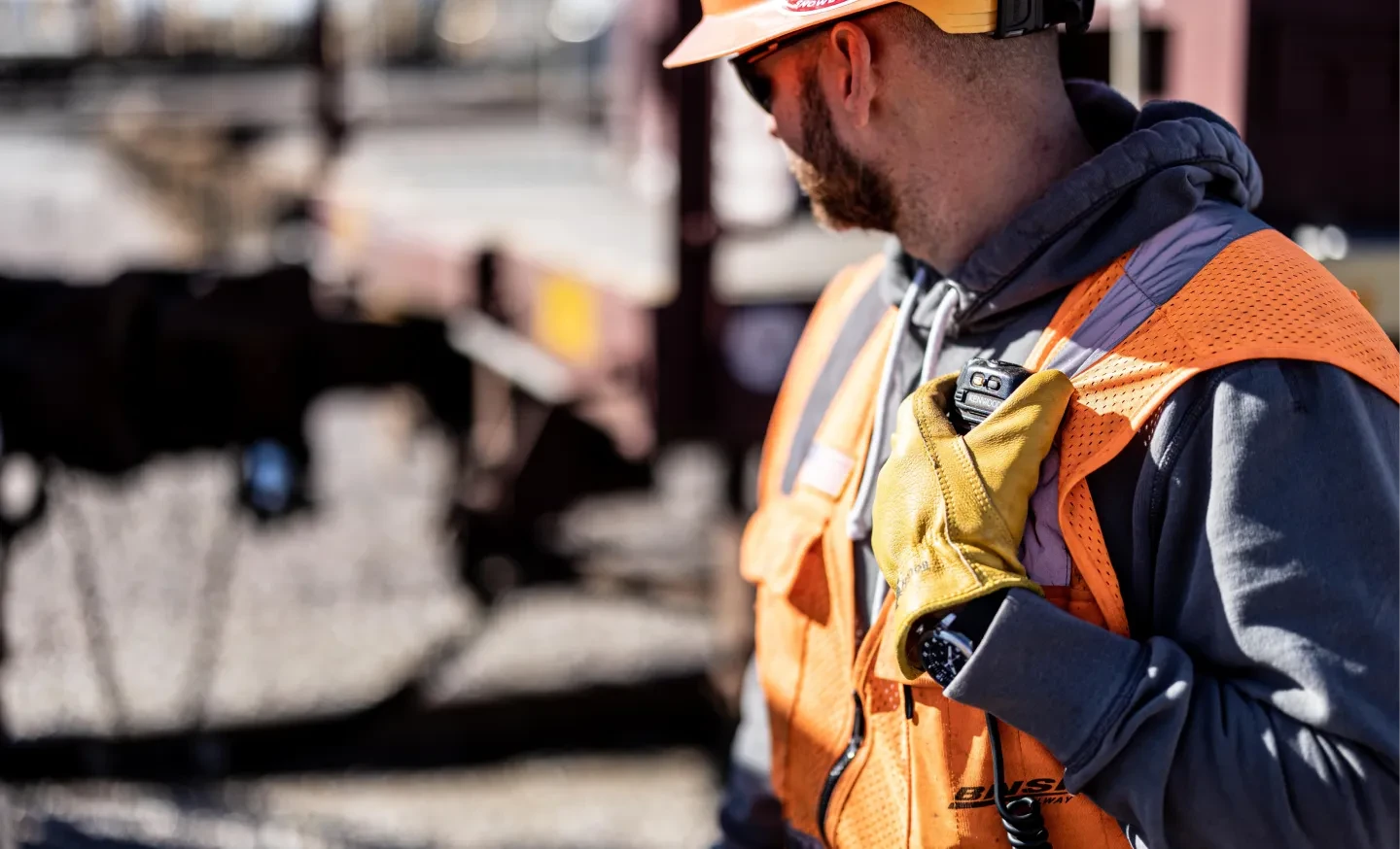 Man with hardhat looking away with radio