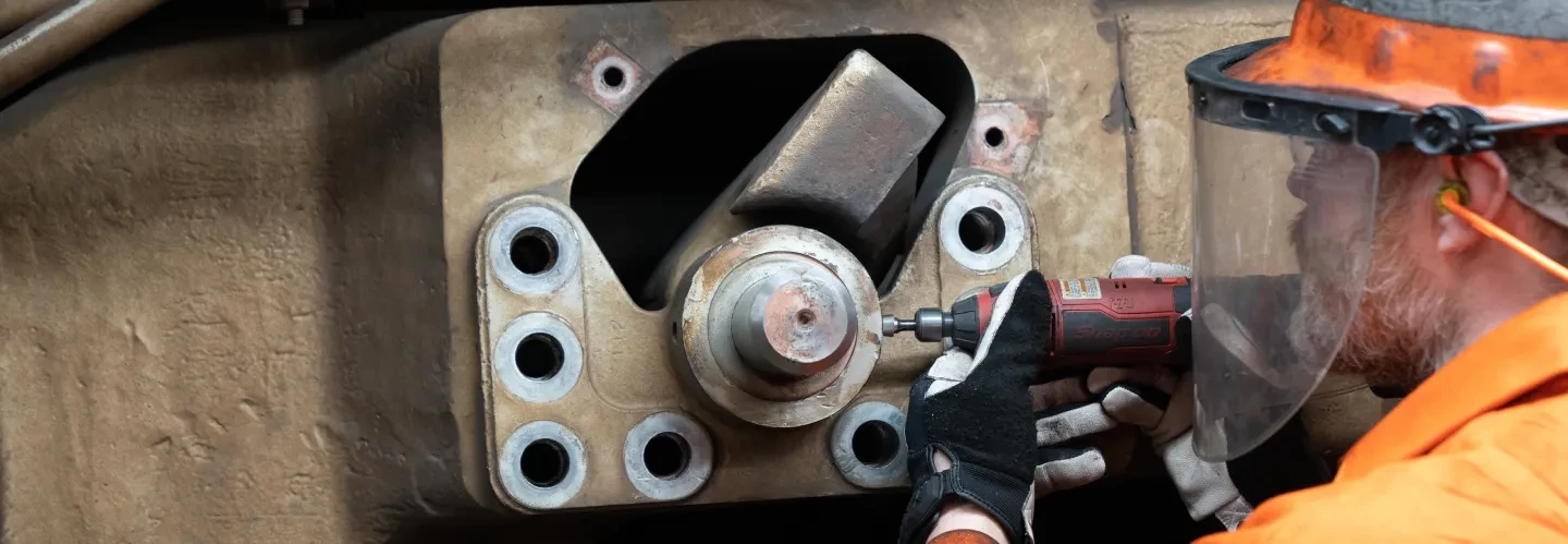 Guy tightening bolts on machine